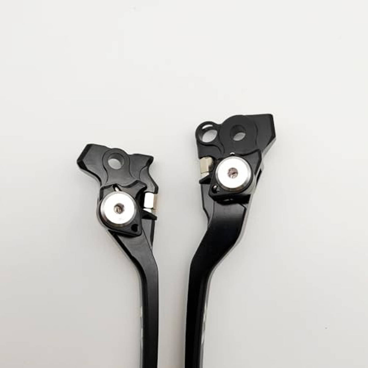 Black brake and clutch lever ends with circular pivot inserts and mounting slots