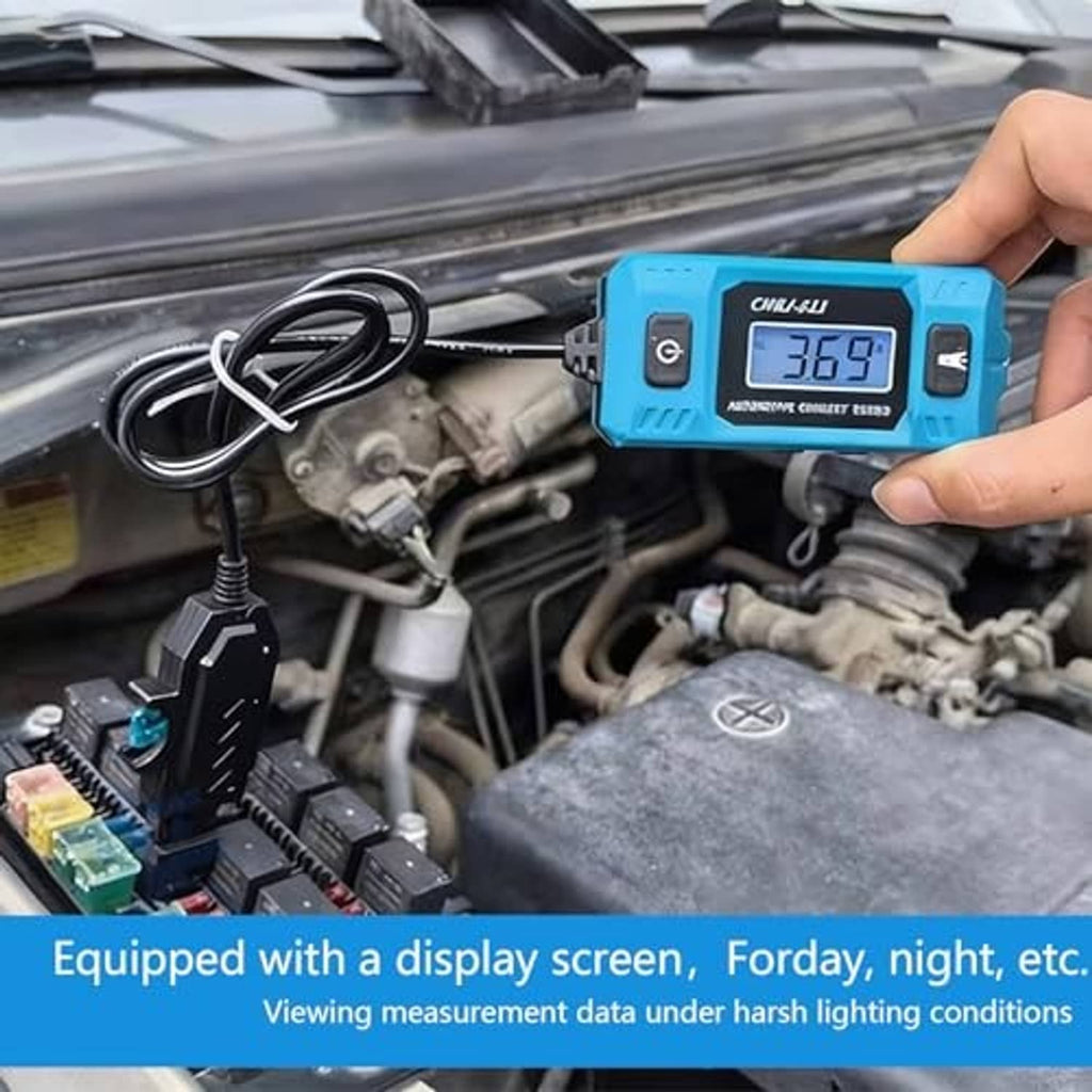Blue automotive circuit tester with LCD display and lead cable held by hand in engine bay