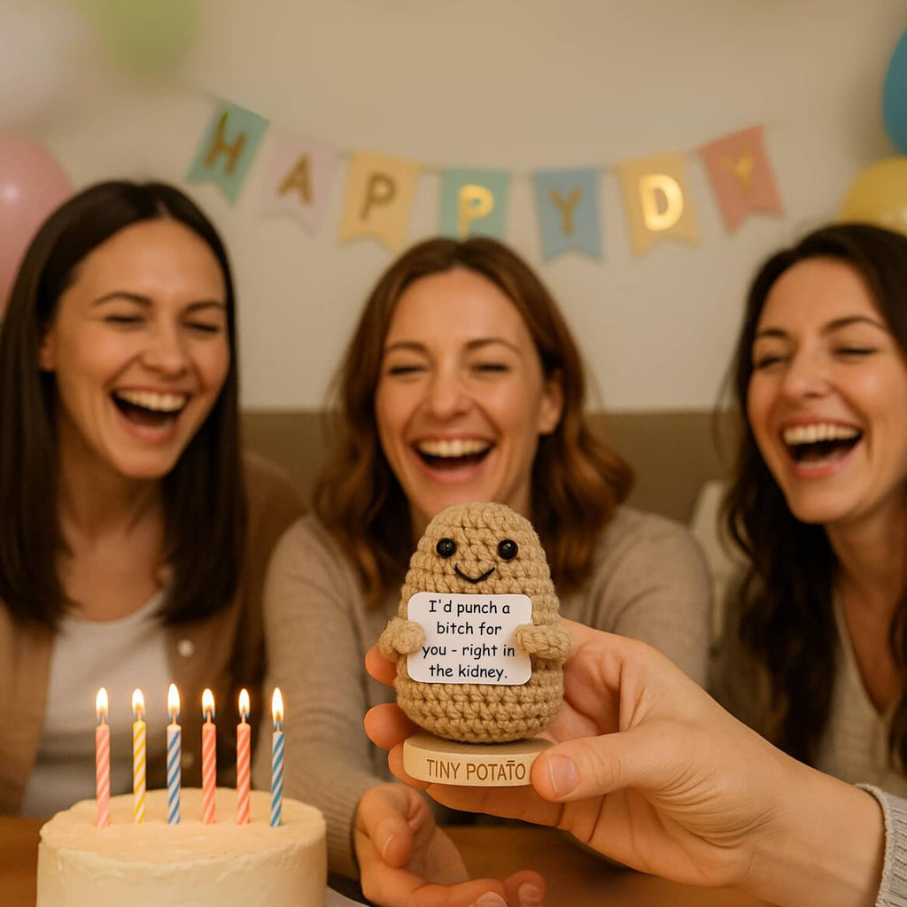 Small crochet potato figurine held up near birthday cake candles, smiling face