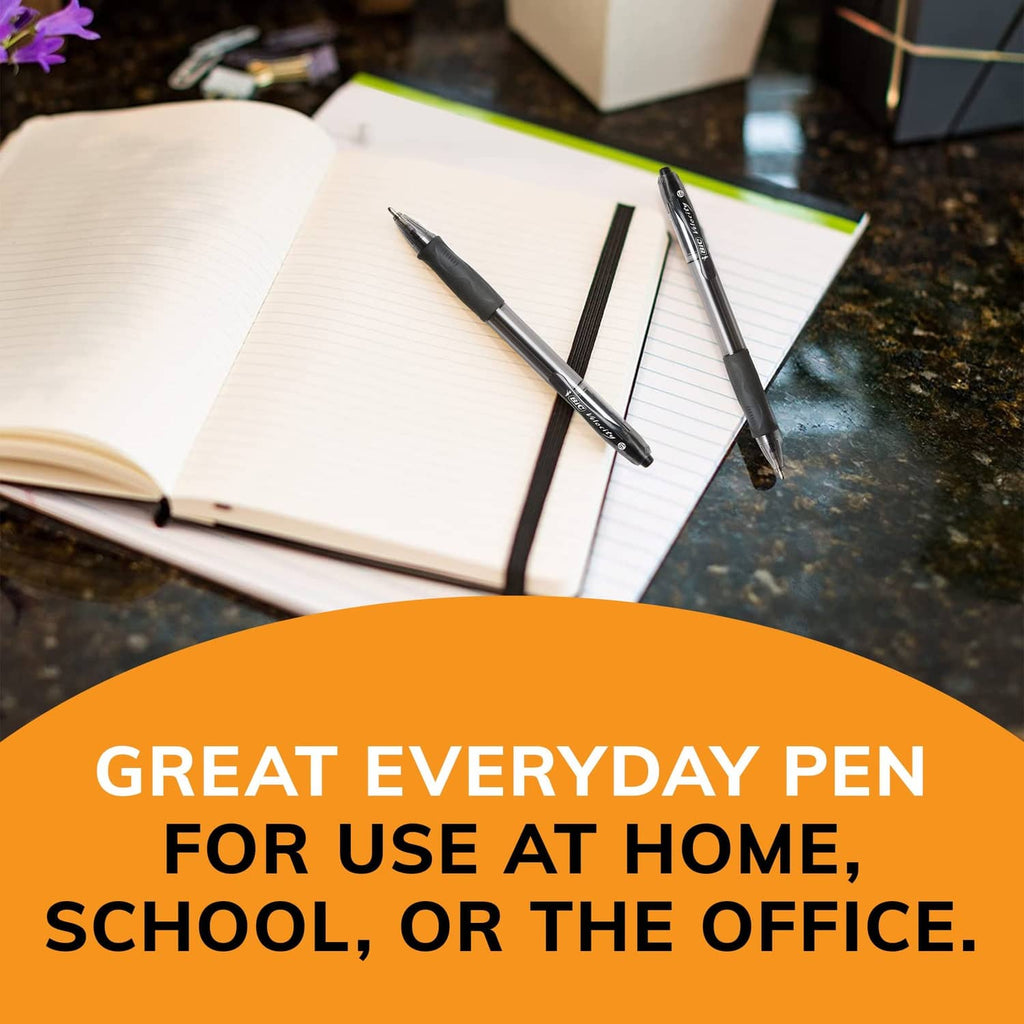 Set of retractable black ballpoint pens resting on an open notebook.