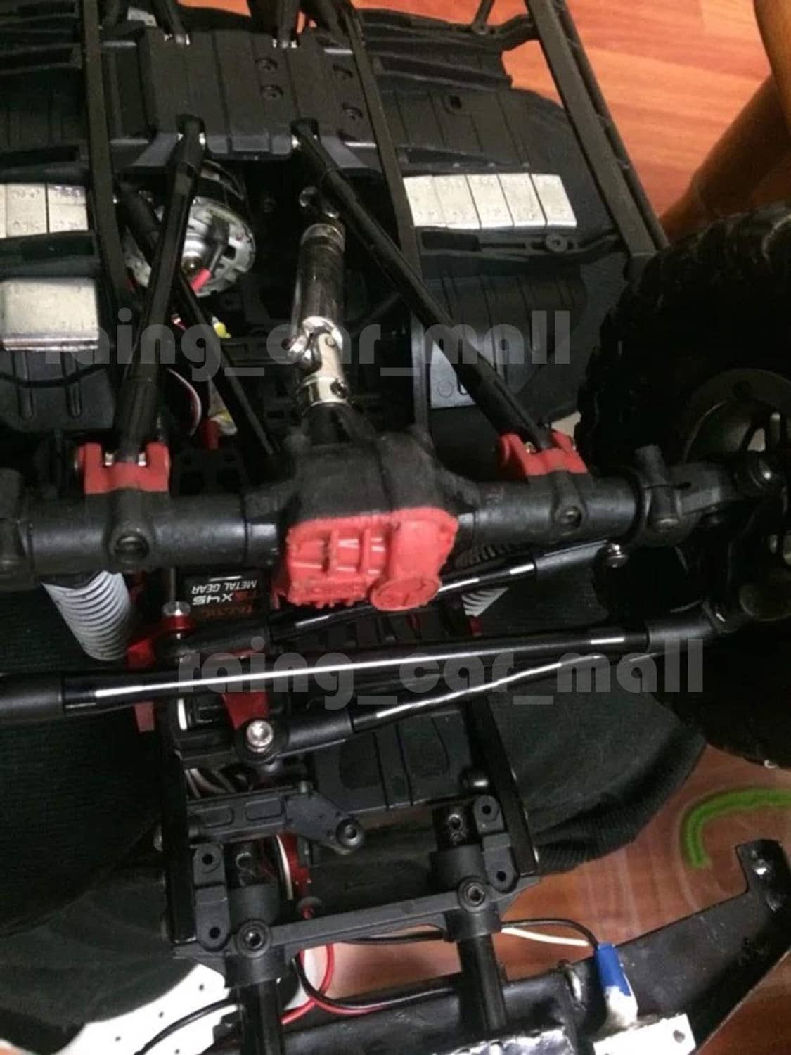 Black rod linkages on an RC truck chassis, angled view of mounted bars