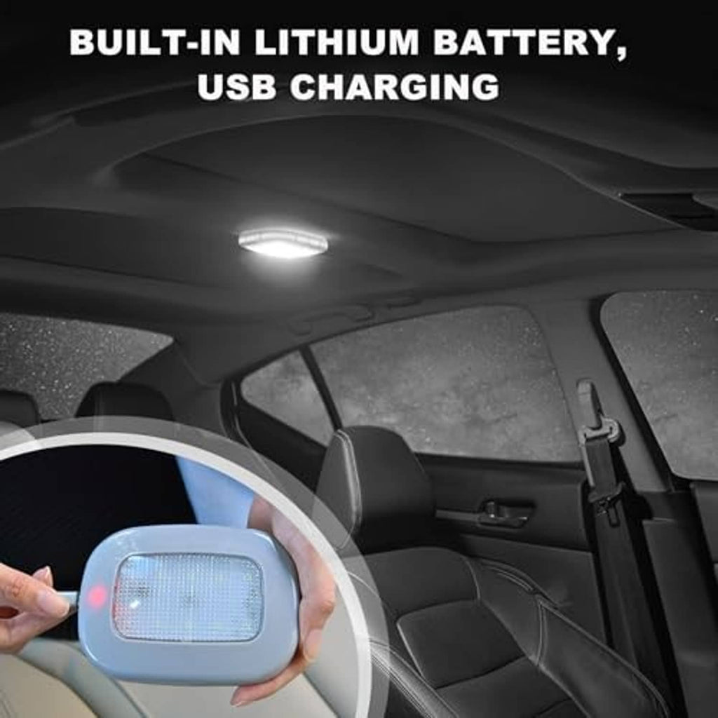 Hand holding black dome car reading light with bright LED glow