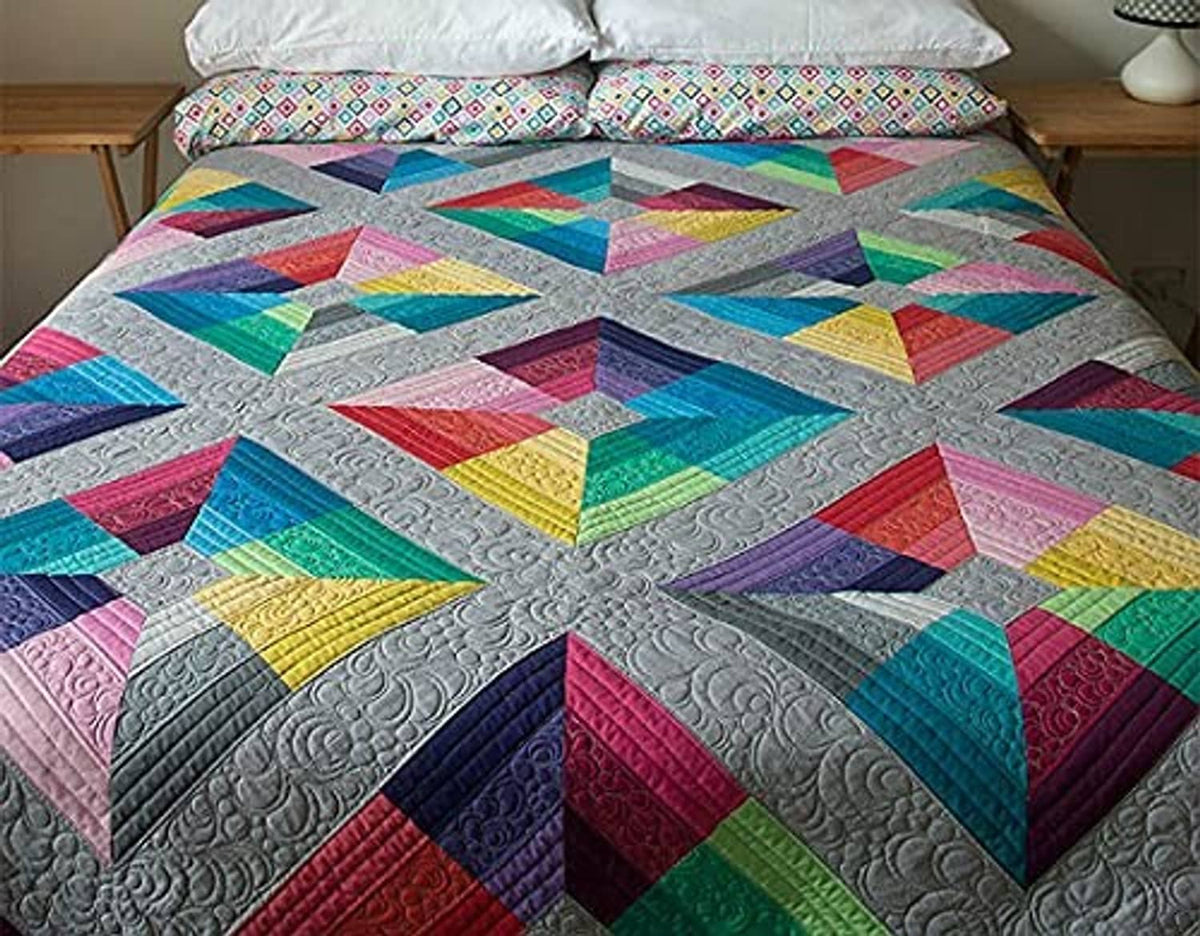 Patchwork fabric quilt top with geometric blocks in bright multicolor prints