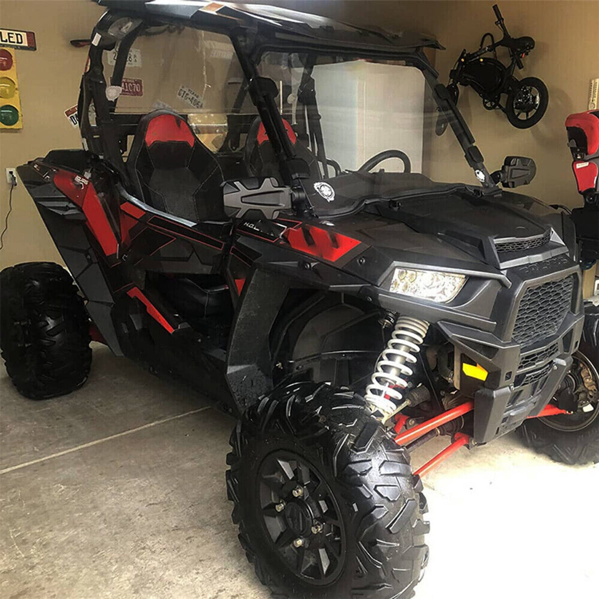 Front side fender flares on a red and black UTV, set of two matching pieces