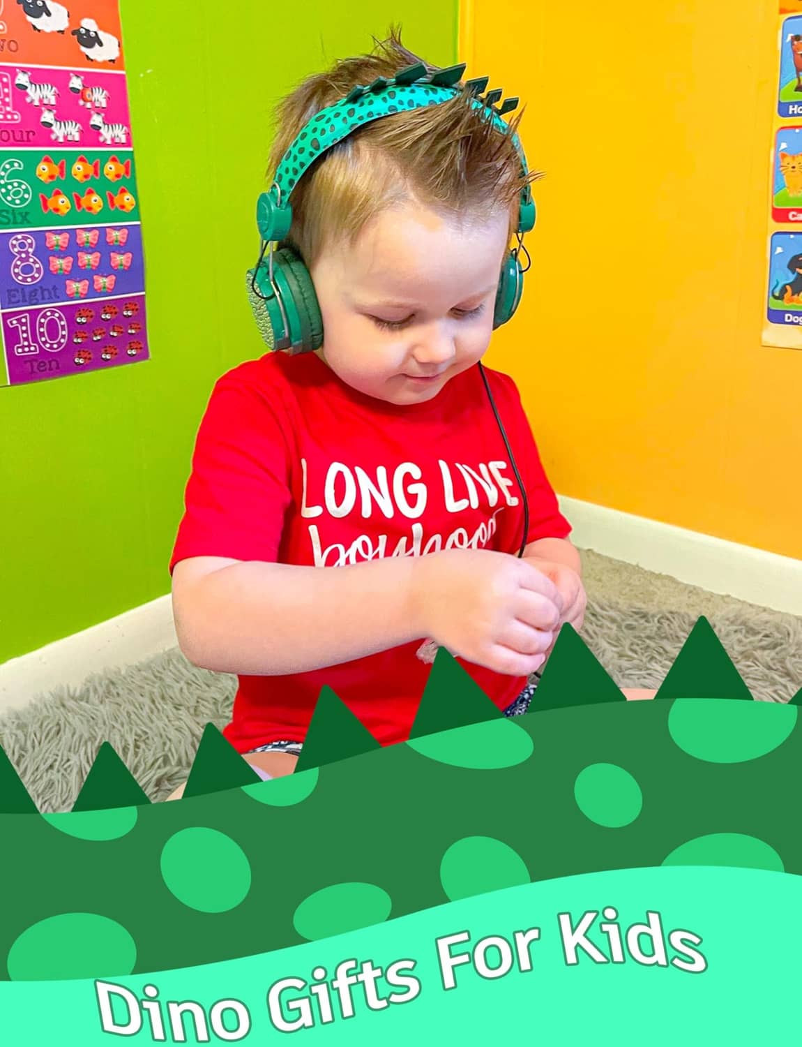 Green dinosaur kids wired headphones worn by a child with cushioned over-ear pads