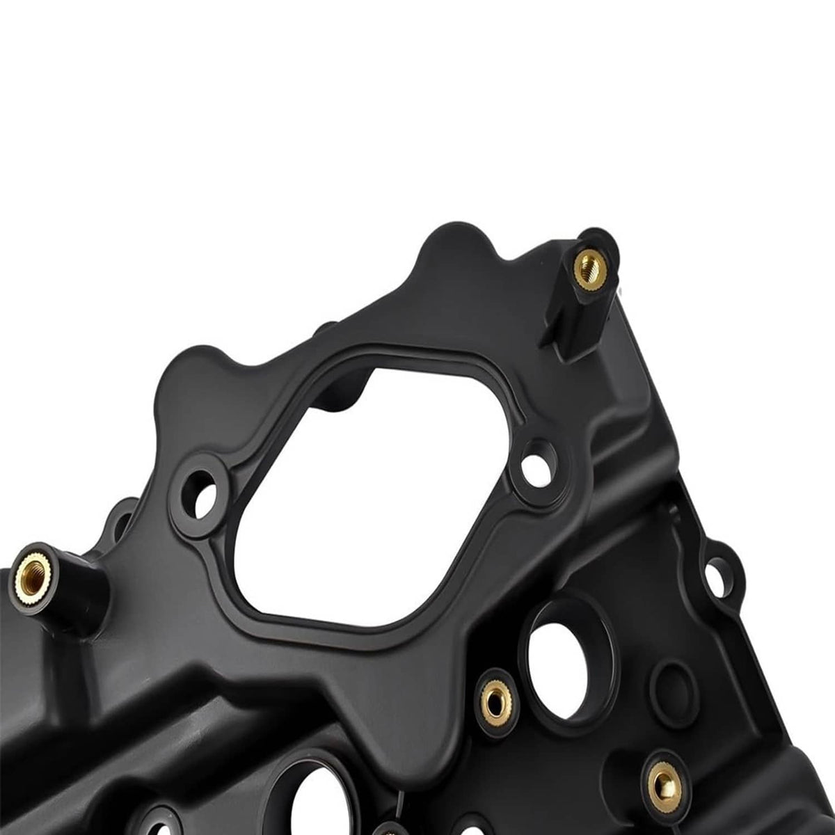 Close-up of black valve cover with gasket surface and circular openings.