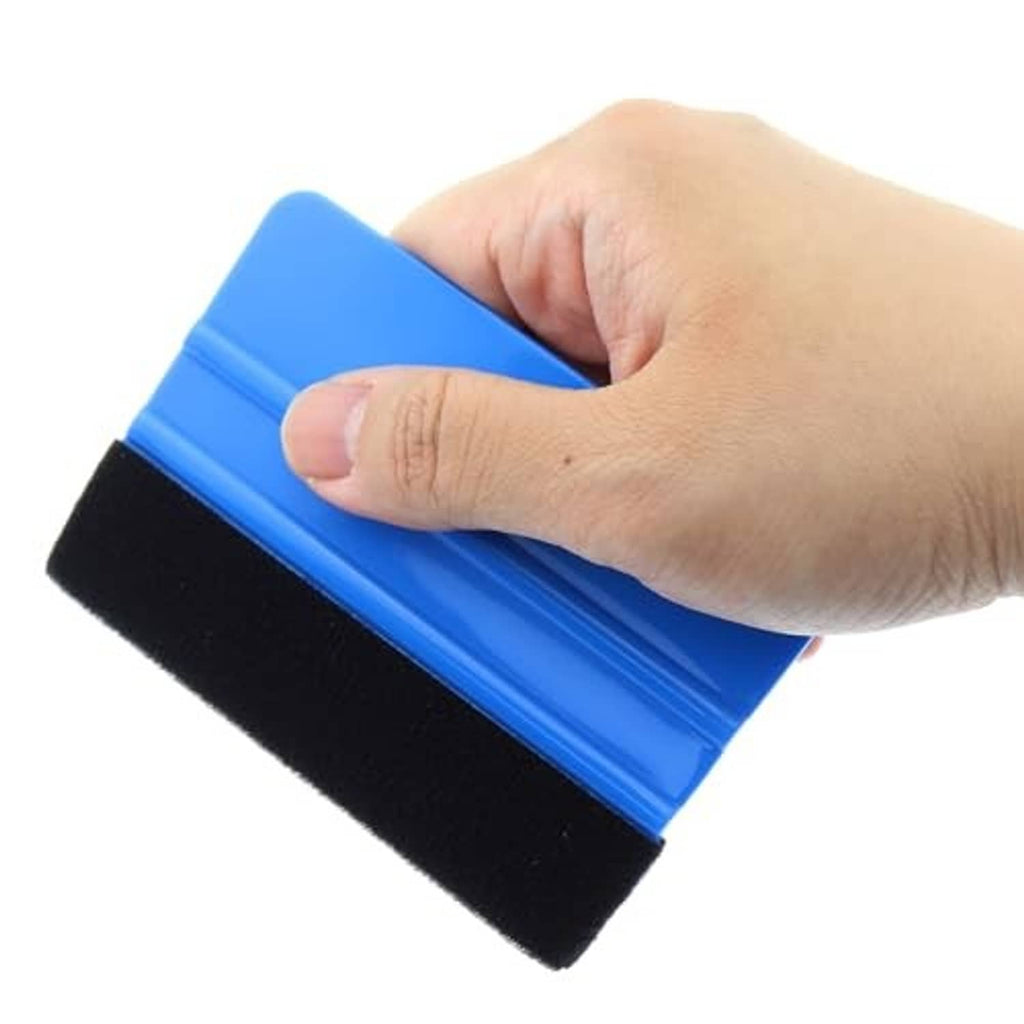 Hand holding a blue squeegee with black foam pad for applying vinyl or tint