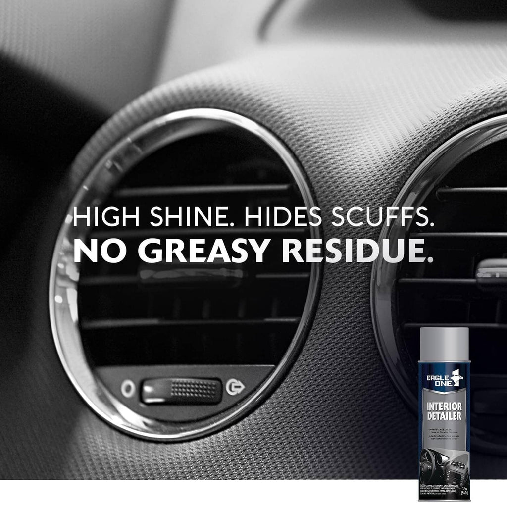 Interior detailer spray bottle beside dashboard air vent on dark textured panel