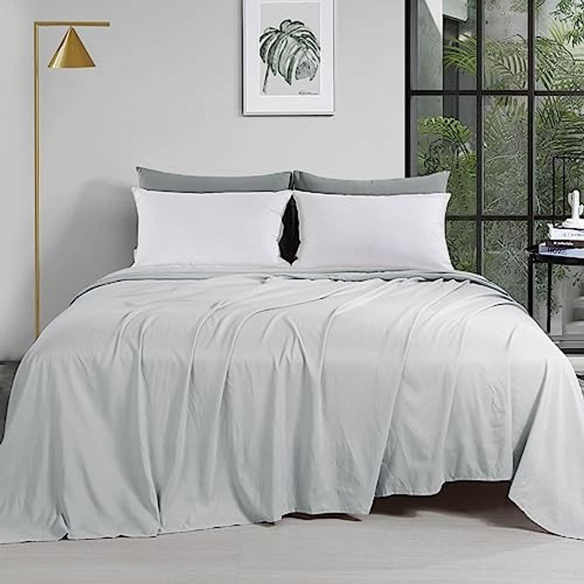 Light grey oversized king flat sheet on bed, neatly draped and smooth