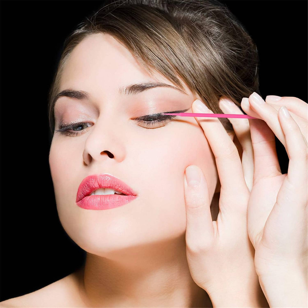 Pink micro cotton swab applying along the eyelid for makeup or lash styling