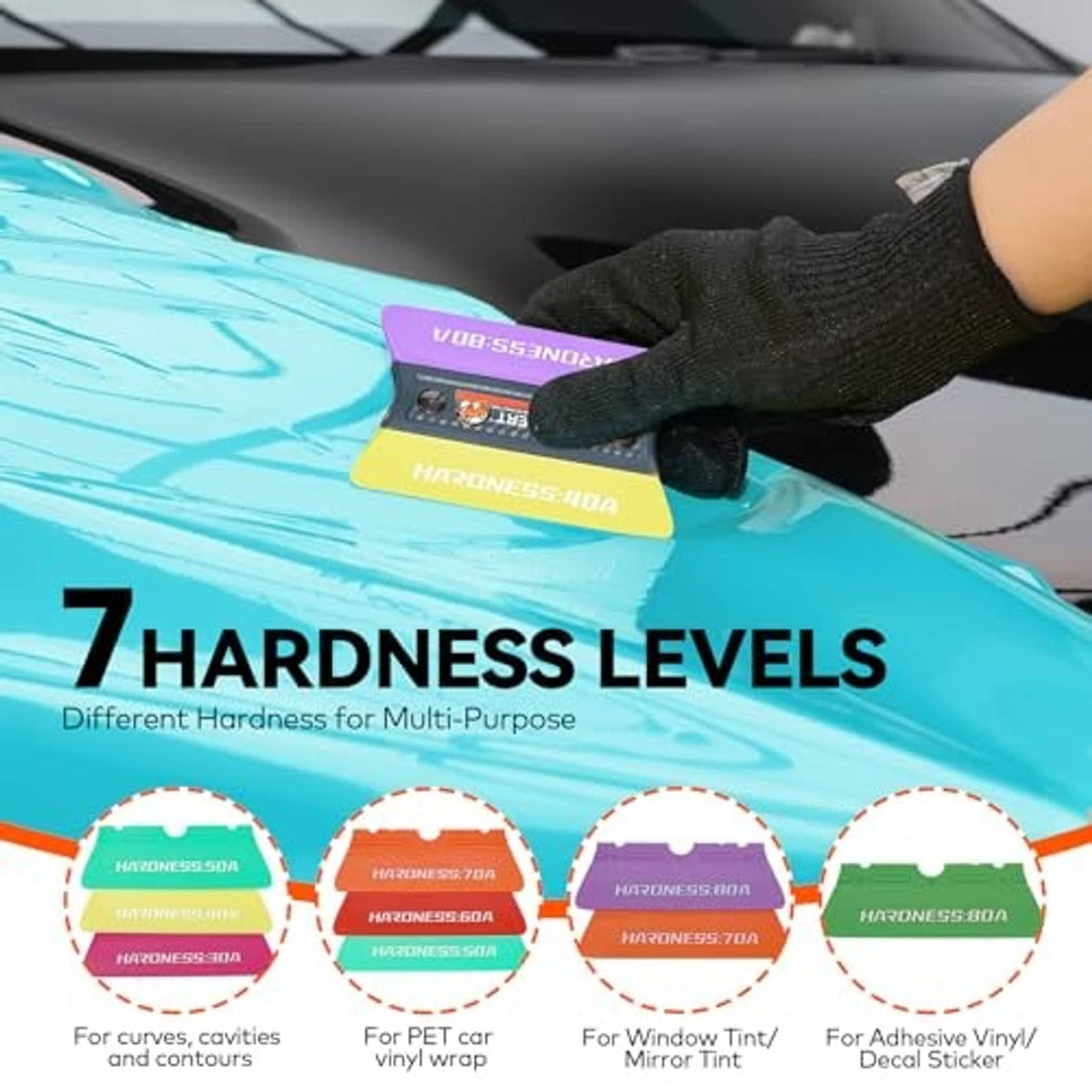 Gloved hand pressing a felt magnetic squeegee onto blue vinyl film on a car