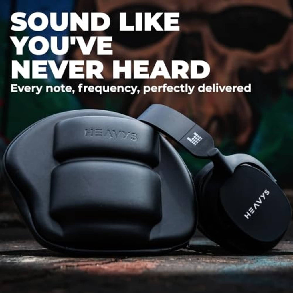 Black over-ear wireless headphones resting on a surface, with padded ear cups.