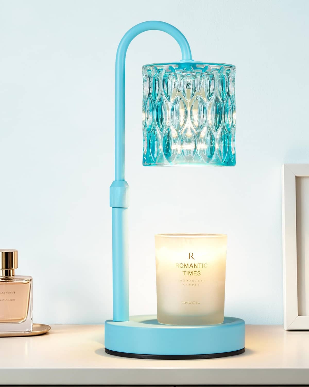 Blue candle warmer lamp with ribbed glass shade and handle, warming a jar candle