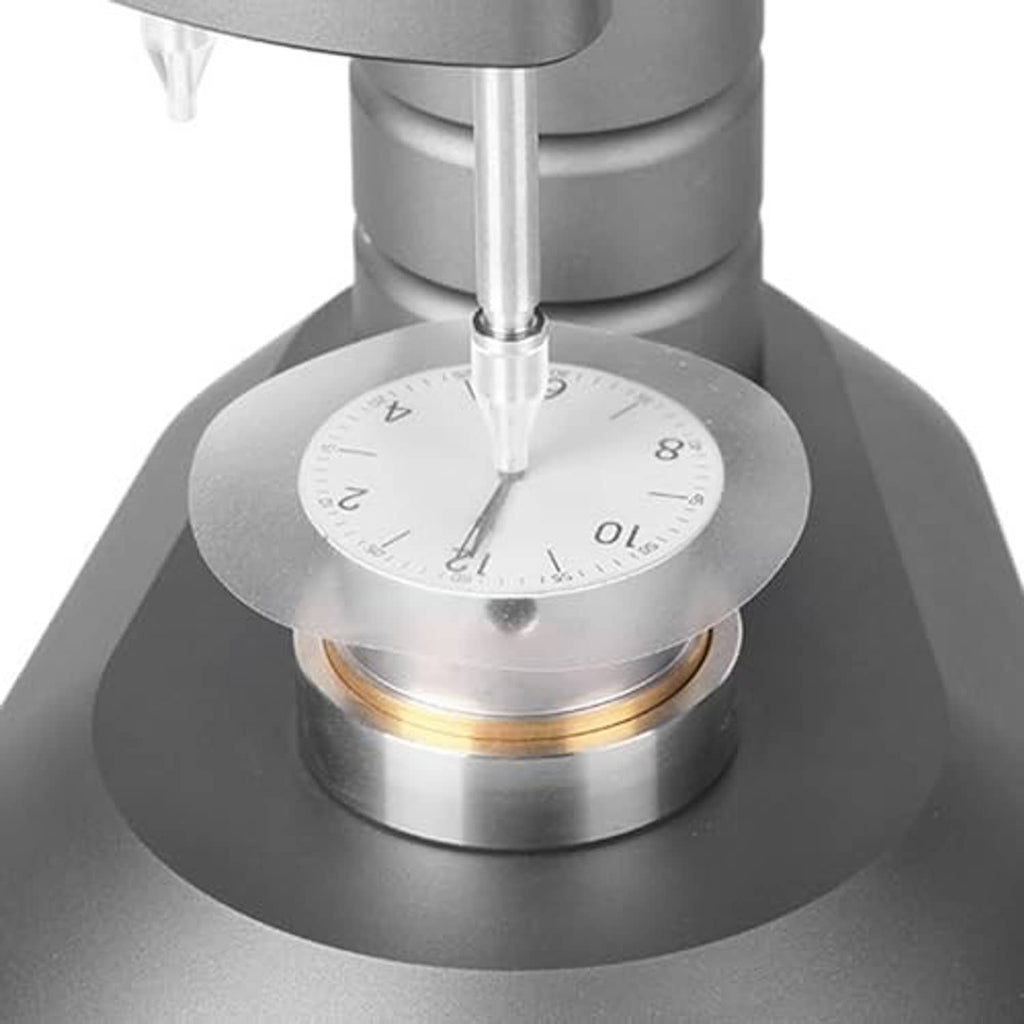 Clear watch dial case back pad protector disc placed under a watch stem tool