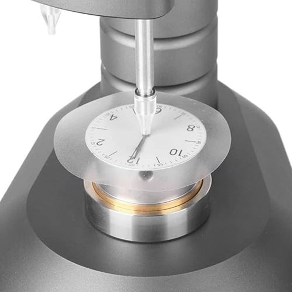 Clear watch dial case back pad protector disc placed under a watch stem tool