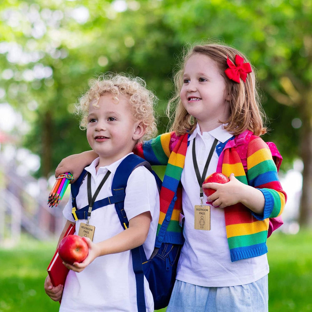 Kids wearing lanyard with wooden restroom pass cards, colorful outfit set
