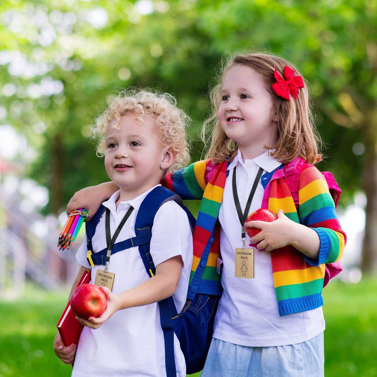 Kids wearing lanyard with wooden restroom pass cards, colorful outfit set