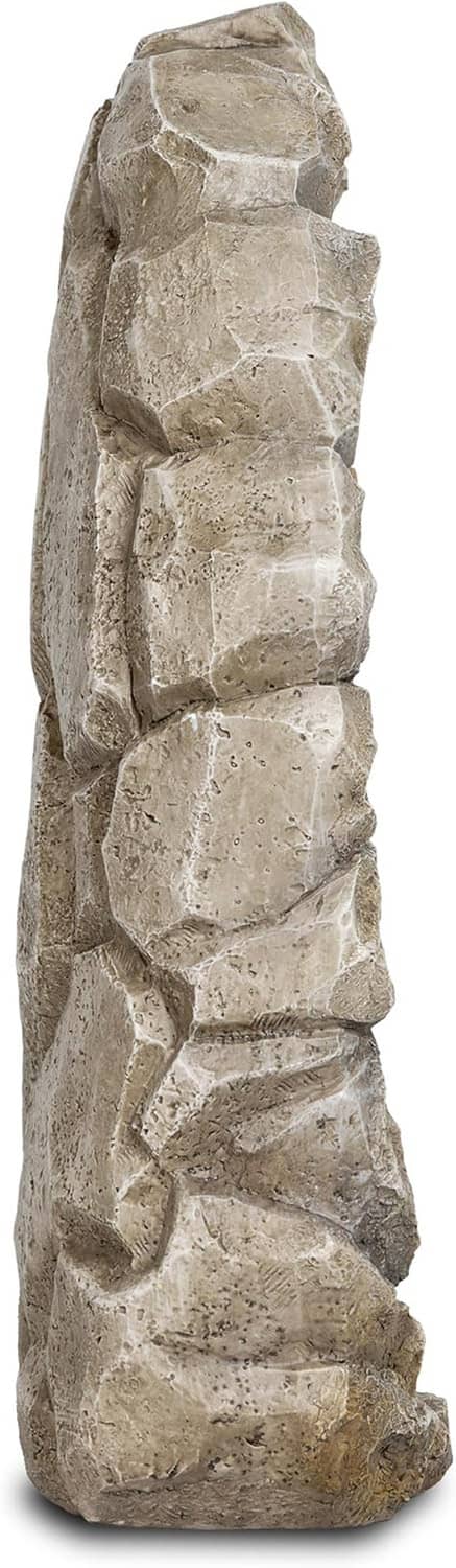 Rough gray stone statue back, vertical carved rock texture with layered relief.