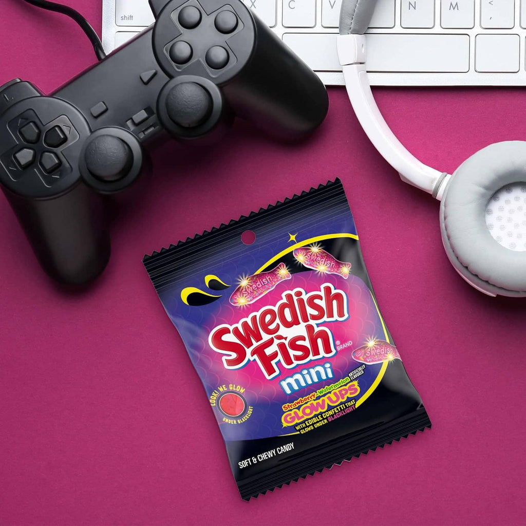 Swedish Fish mini glowups gummy candy pouch, sealed package with purple Swedish Fish graphics