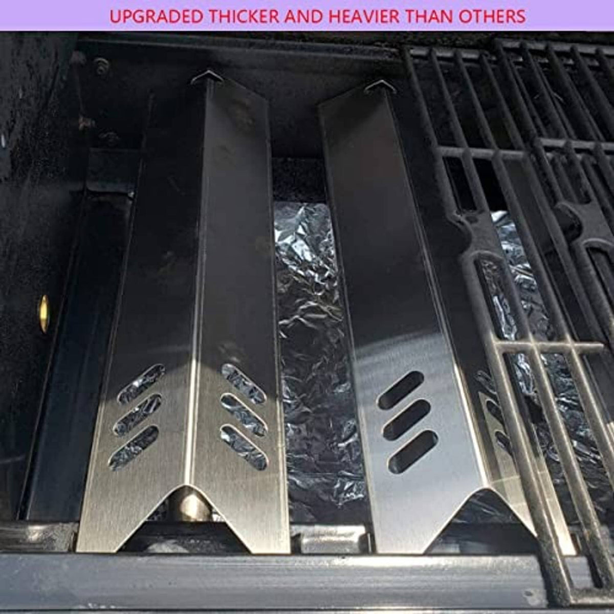 Thick stainless steel heat plates installed on a grill, vent slots visible