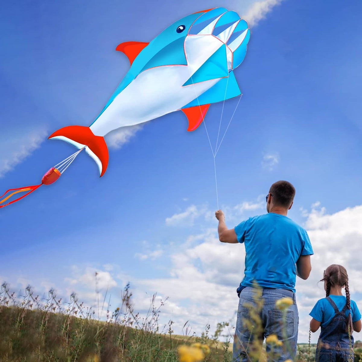 Blue 3D dolphin kite with white belly and red fins, diamond-pattern sail and flying line