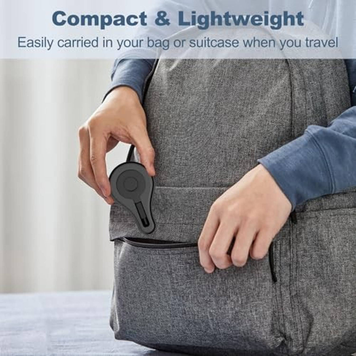 Black silicone charger stand held in a hand, compact travel charging base