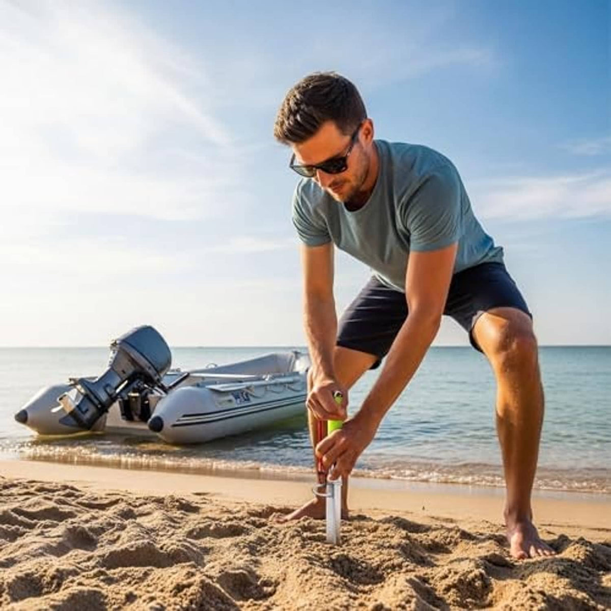 Sand spike boat anchor with neon green handle and silver pole planted in sand.