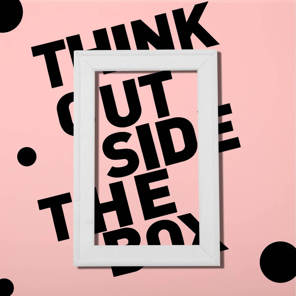 Bold black vinyl letter stickers inside a white frame on a pink background