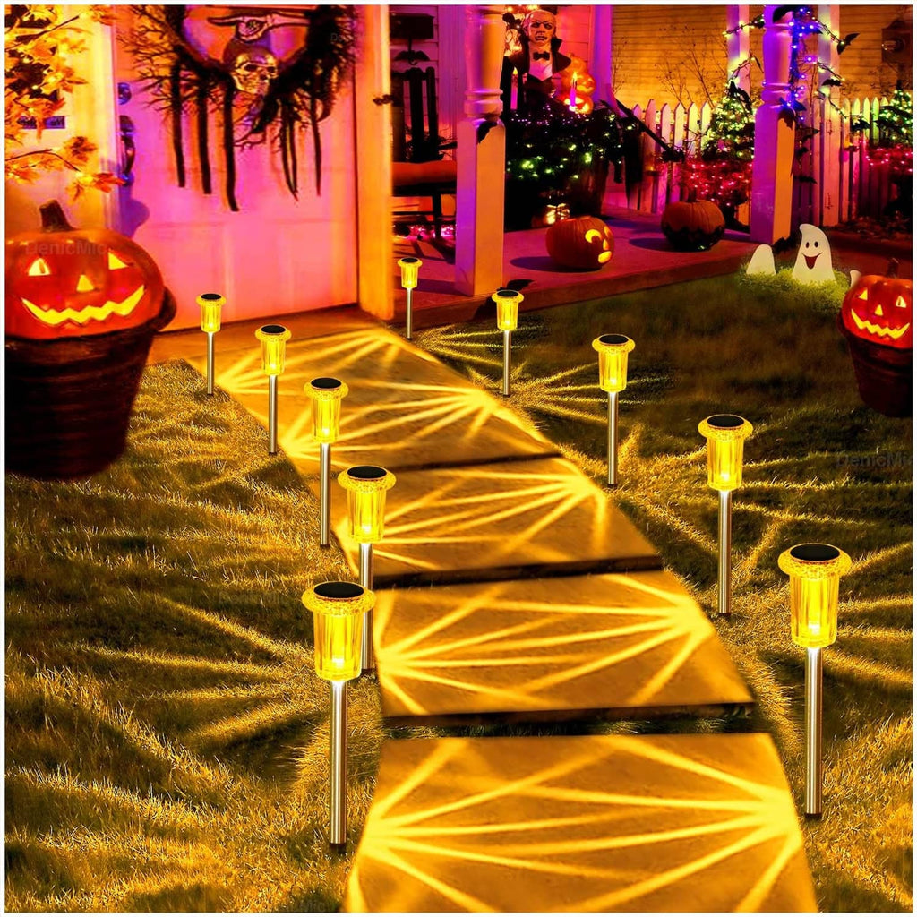 Multiple amber solar spike lights casting bright starburst patterns on lawn