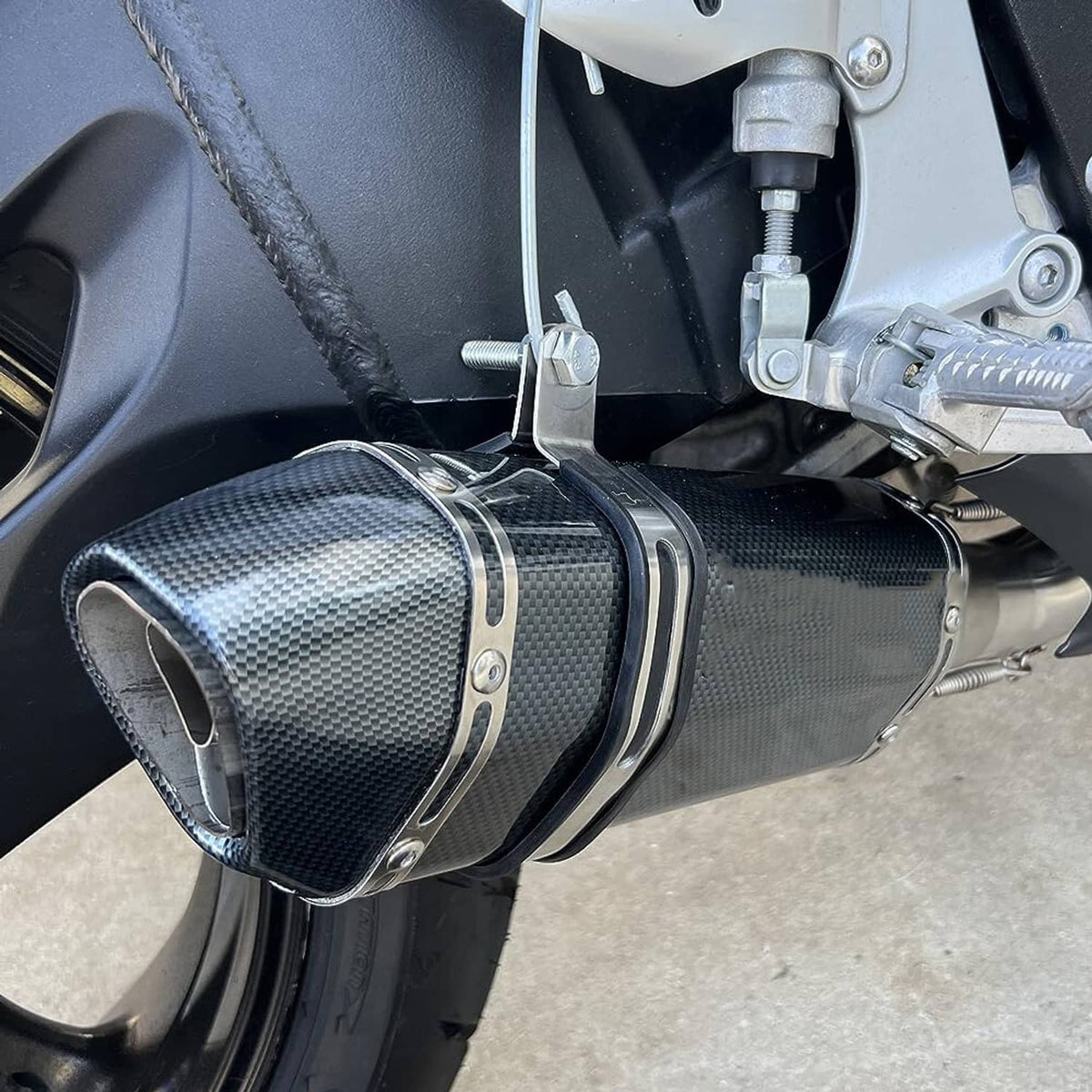 Carbon fiber motorcycle exhaust muffler with black inlet and metal mounting hardware