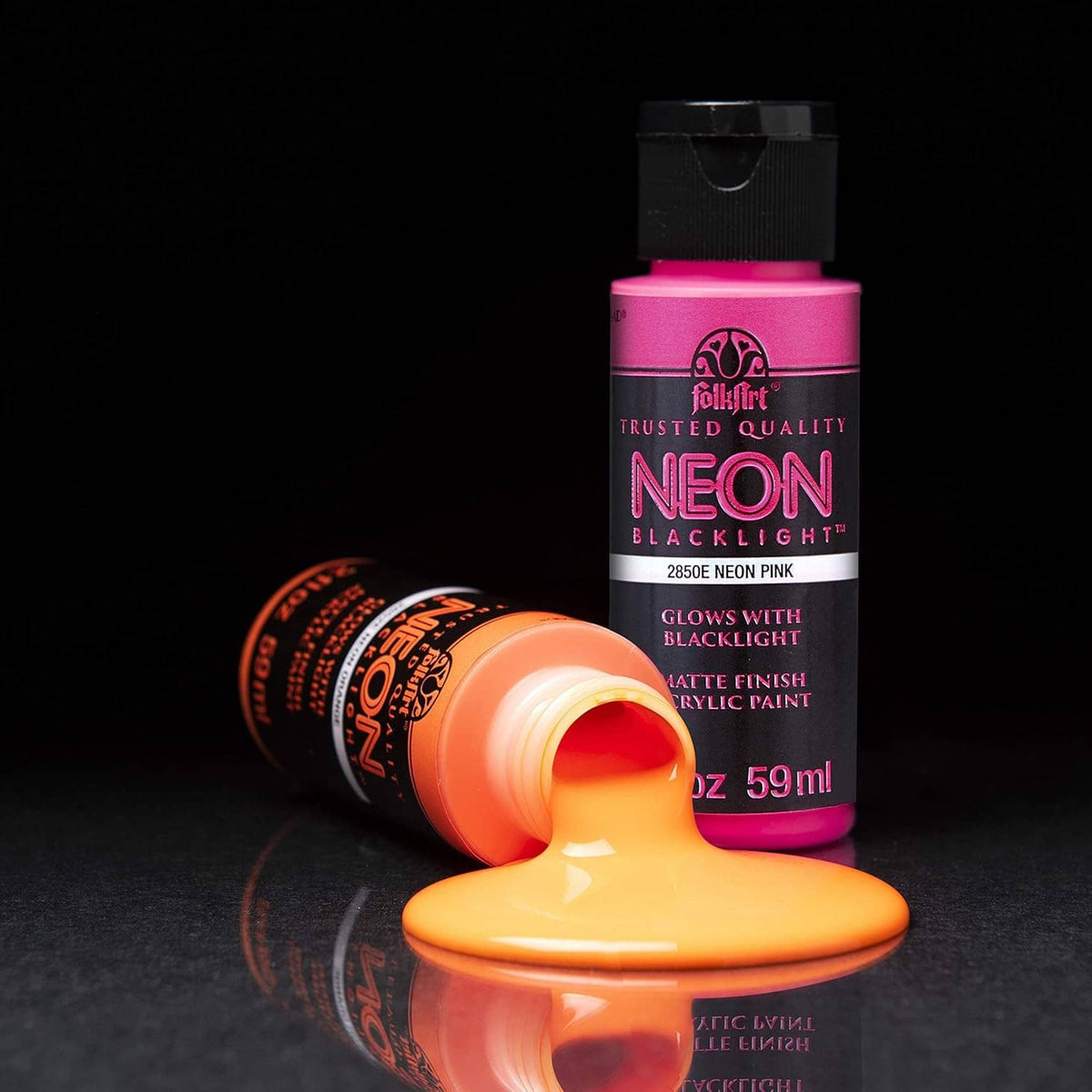 Neon blacklight acrylic paint bottle with pink label and orange paint drop