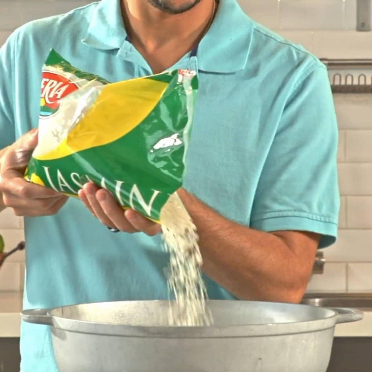 Jasmine rice pouring from a green-and-yellow bag into a large pot