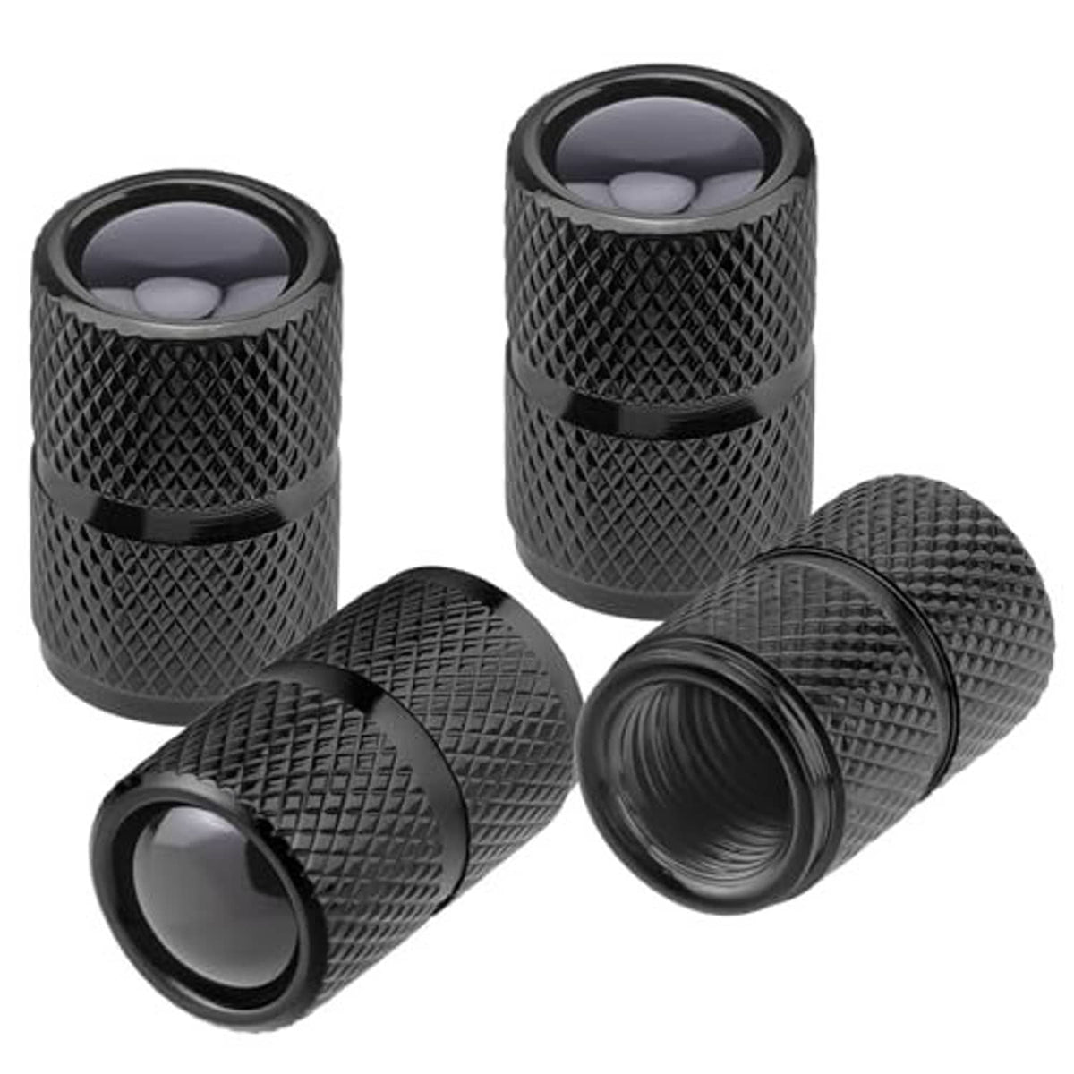Four black aluminum tire valve stem caps with textured sides and protective end covers