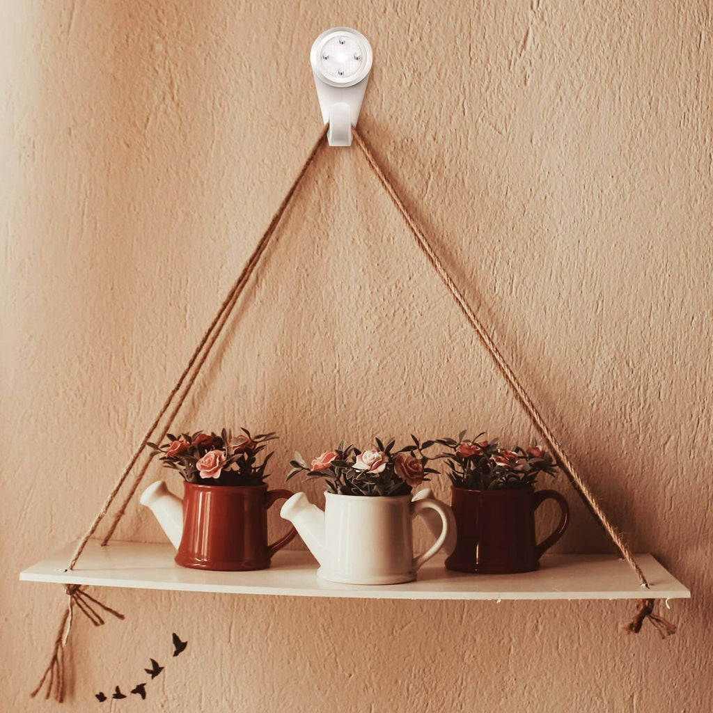 White plastic wall hook with metal pin, holding rope and small shelf