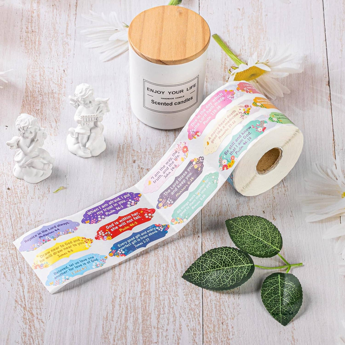 Bible verse sticker roll on white wood surface with pastel scripture labels strip