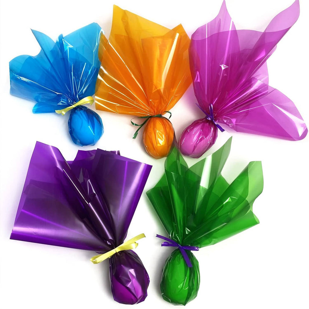 Assorted translucent gift wrap sheets and bows in blue, orange, purple, green