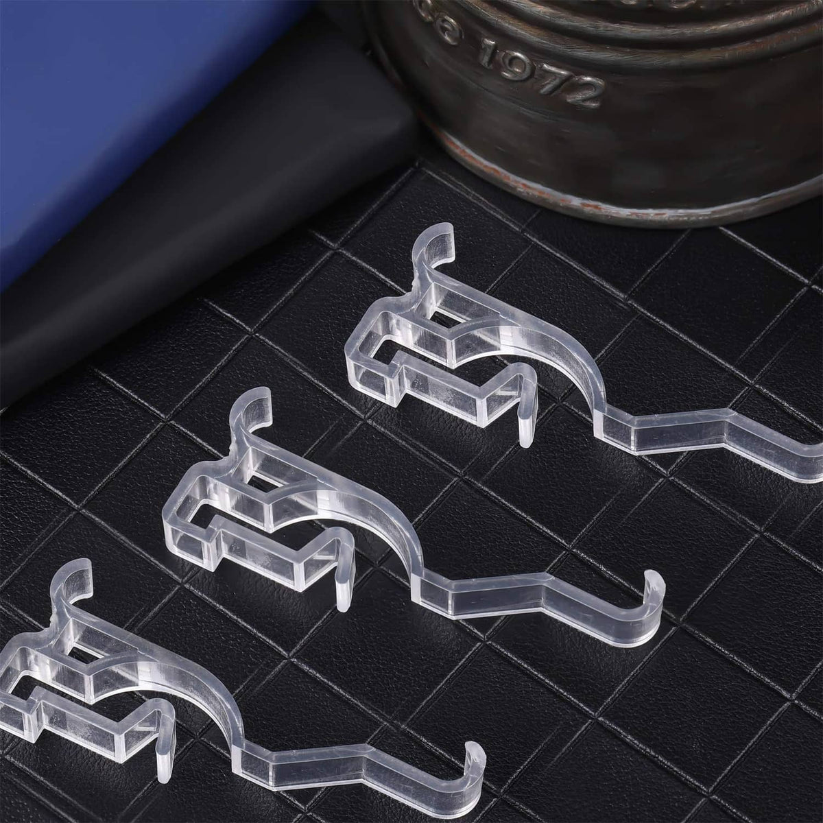 Multiple clear valance retainer clips with curved gripper arms