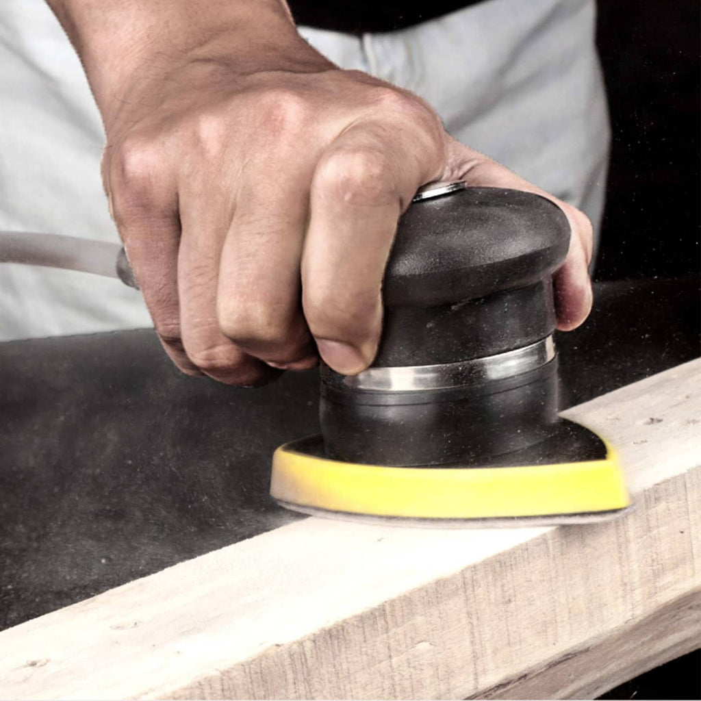 Triangular sanding pad on a sander polishing a wood board surface