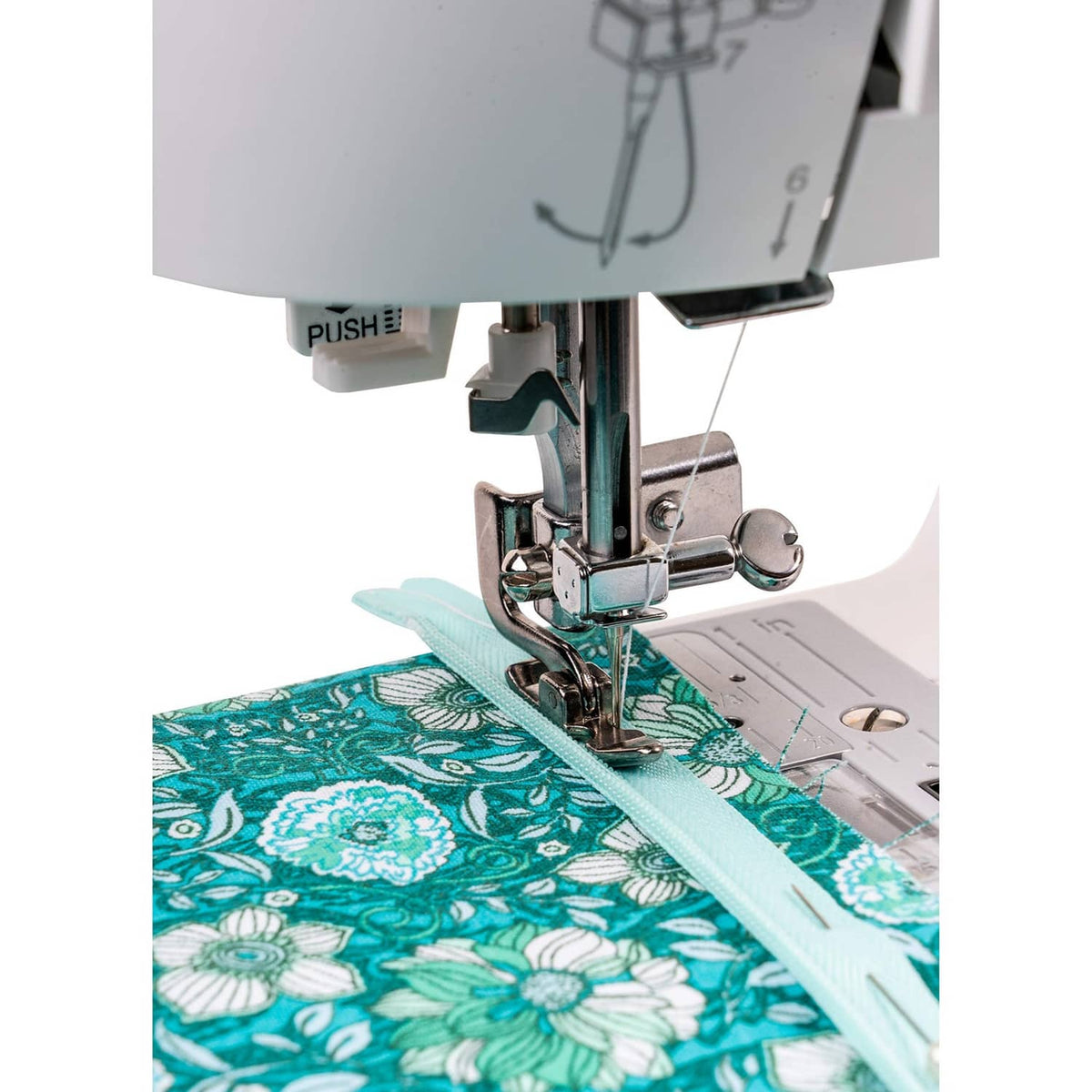 Sewing machine vertical needle zipper foot stitching a turquoise fabric seam