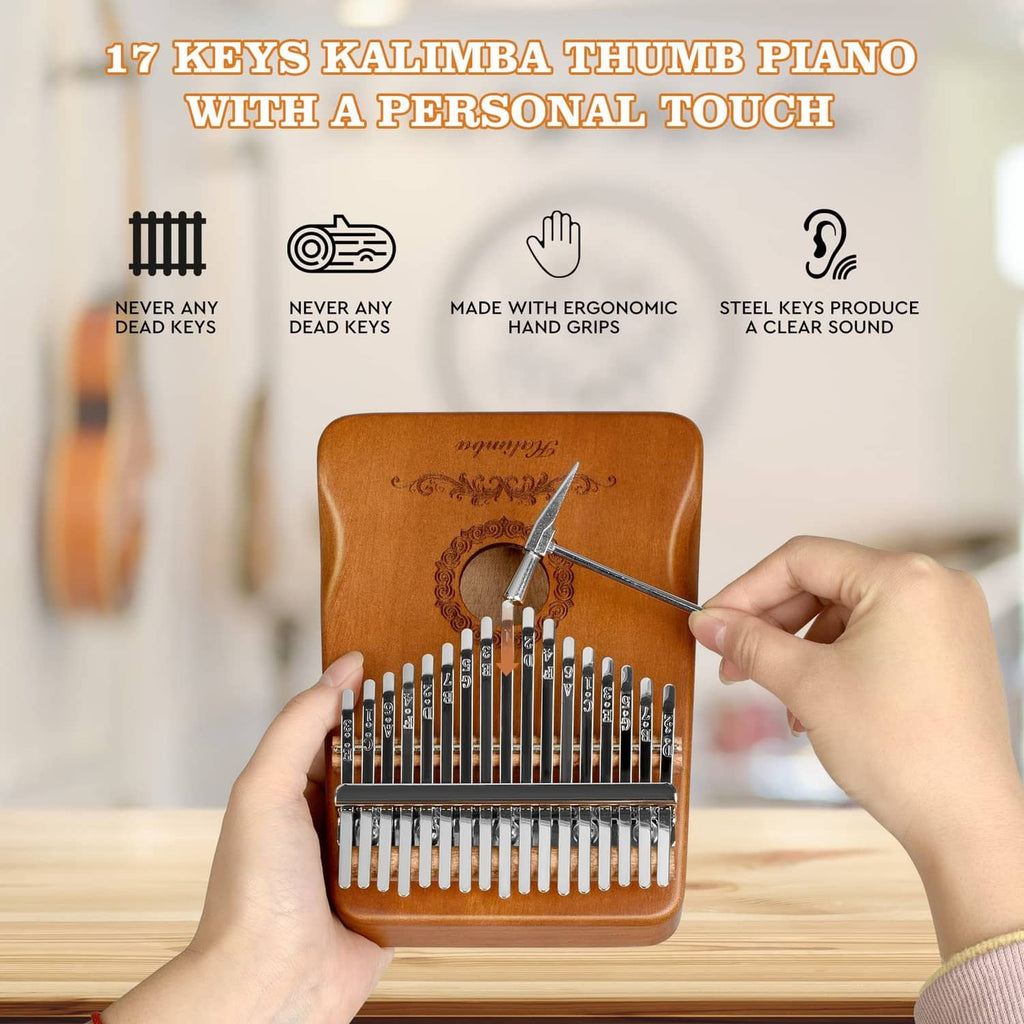 Brown 17-key kalimba with included tuning hammer and engraved front panel on table