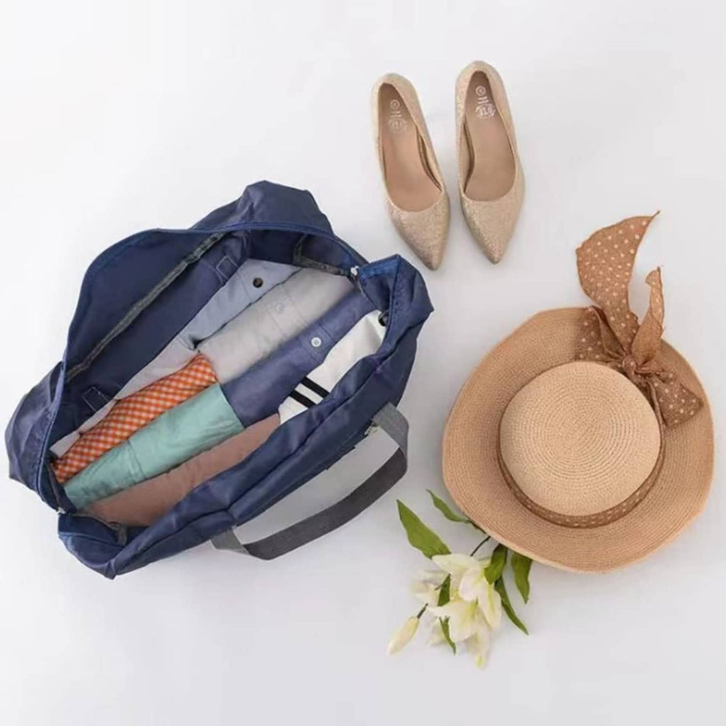 Open navy foldable duffel bag with interior pockets and gray webbing handles