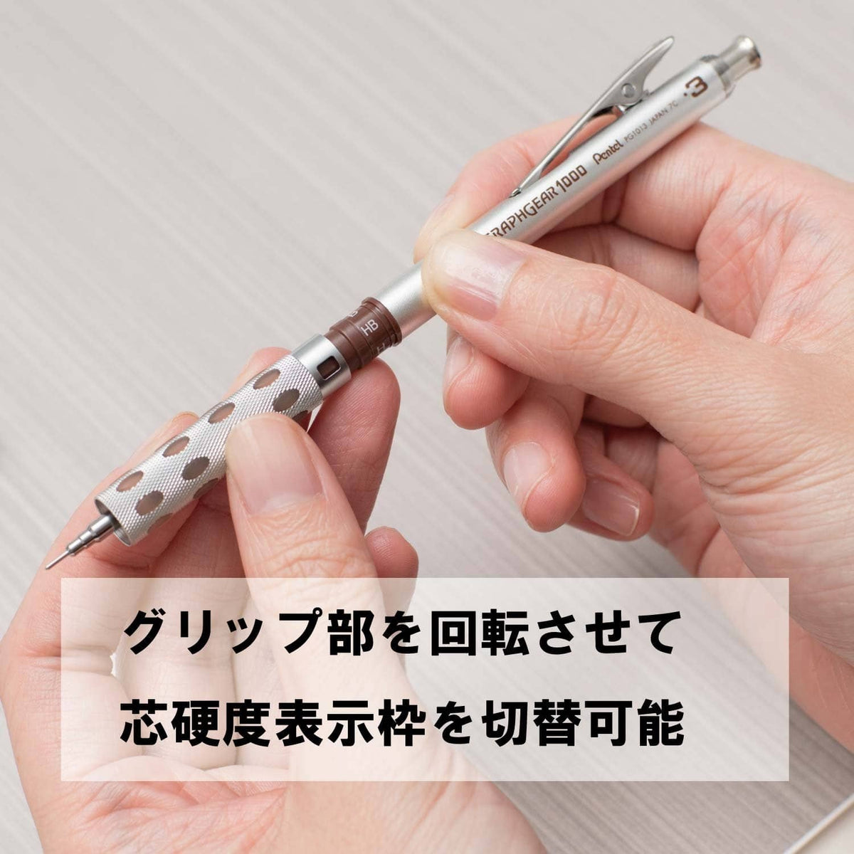 Brown patterned mechanical pencil held in fingers, silver clip and lead sleeve detail