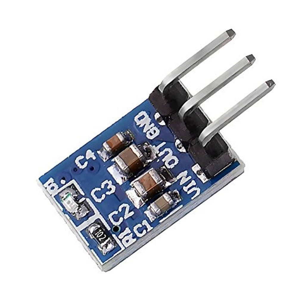 Close-up of blue AMS1117 3.3V step-down voltage regulator board with 3-pin header