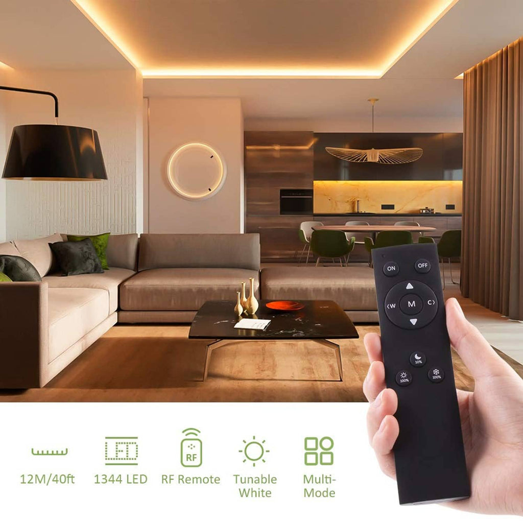 Tunable LED strip remote control held in hand near an indoor ceiling light