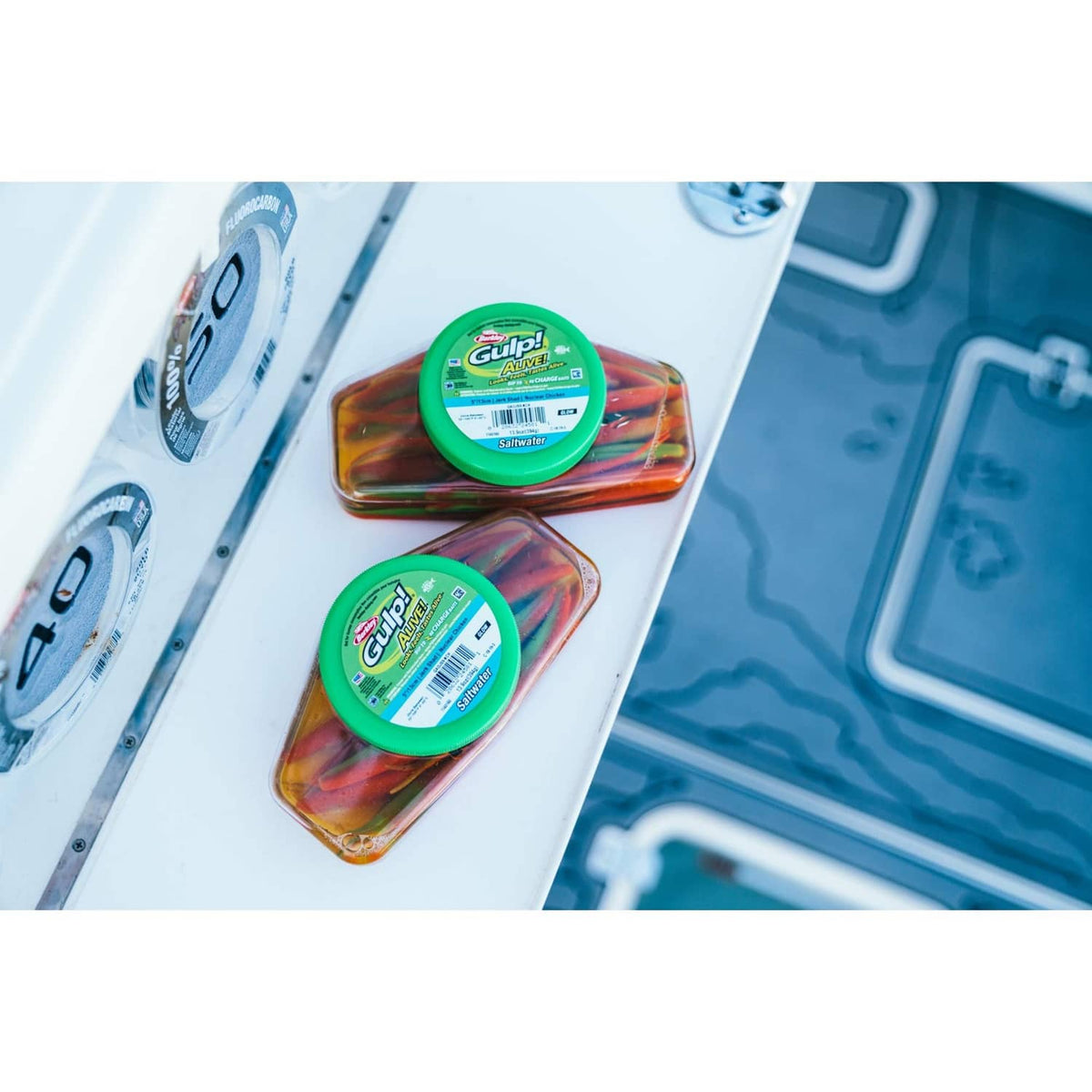 Two Berkley Gulp jerk shad bait containers with green lids