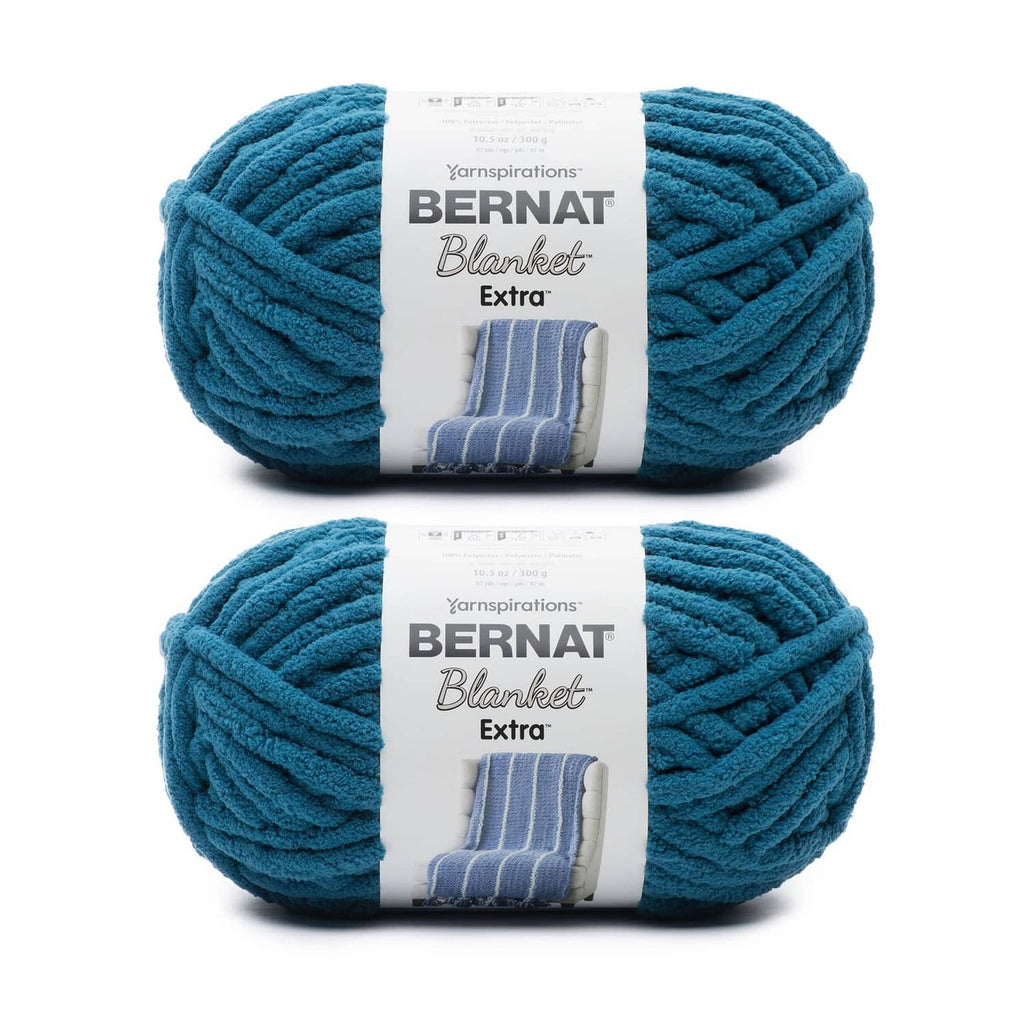 Two jumbo polyester yarn cakes in teal blue, chenille-style Bernat Blanket Extra yarn