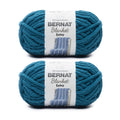 Two jumbo polyester yarn cakes in teal blue, chenille-style Bernat Blanket Extra yarn