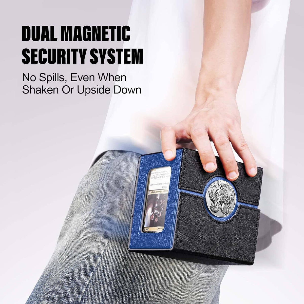 Black and blue deck box with metal emblem, held closed by a hand