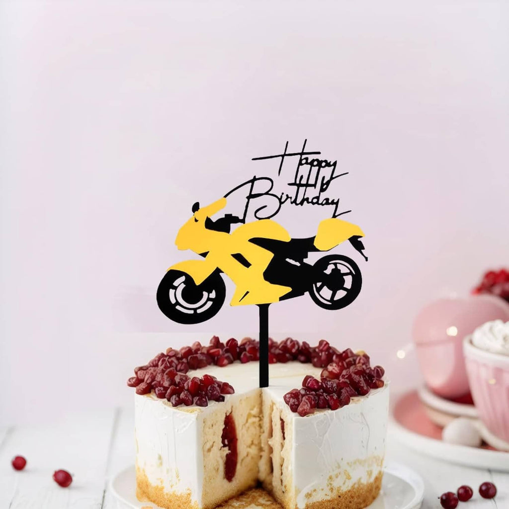 Motorcycle cake topper with black-and-yellow scooter and 'Happy Birthday' text on a stick