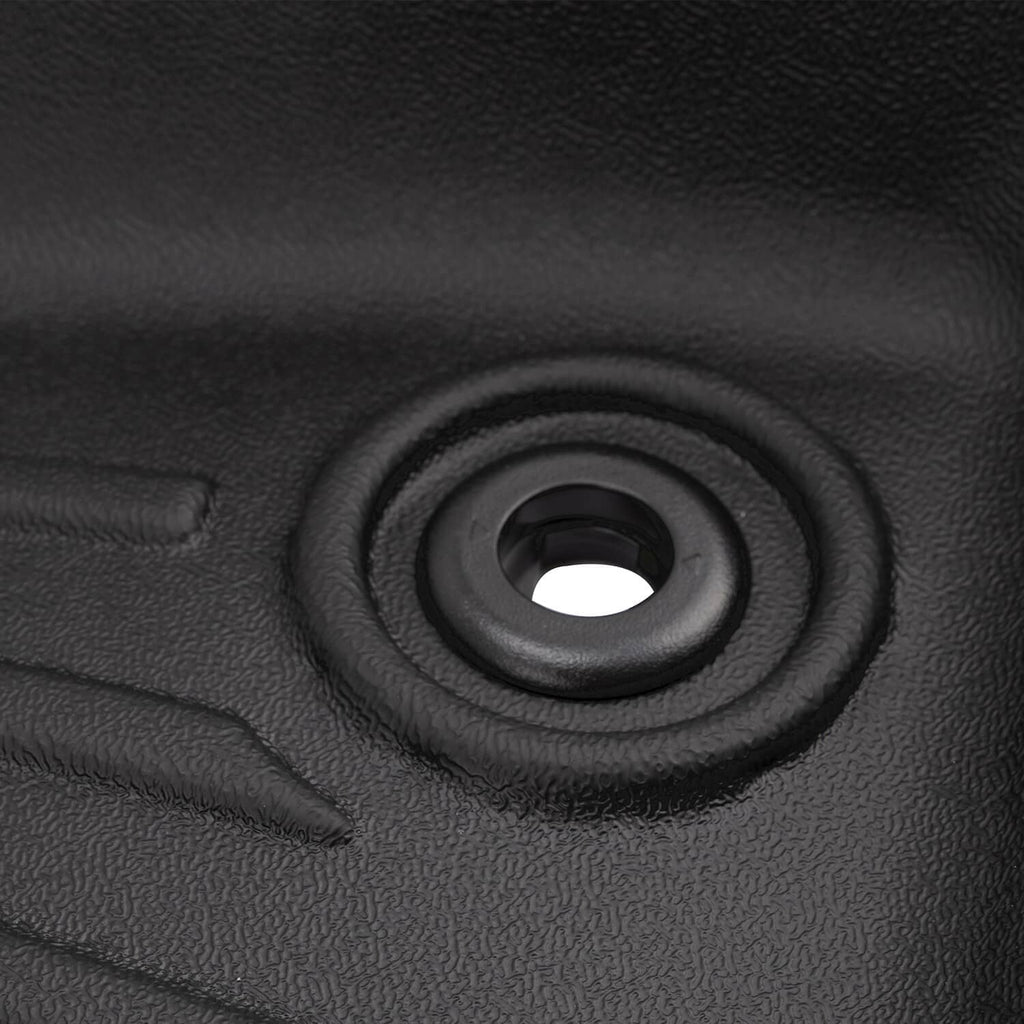 Close-up of black rubber mat grommet/anchor opening with reinforced surround
